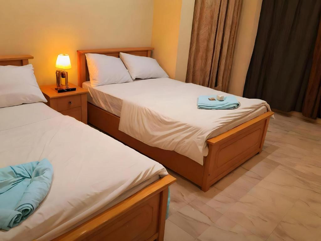 Postel nebo postele na pokoji v ubytování Pyramids Grand View Hotel