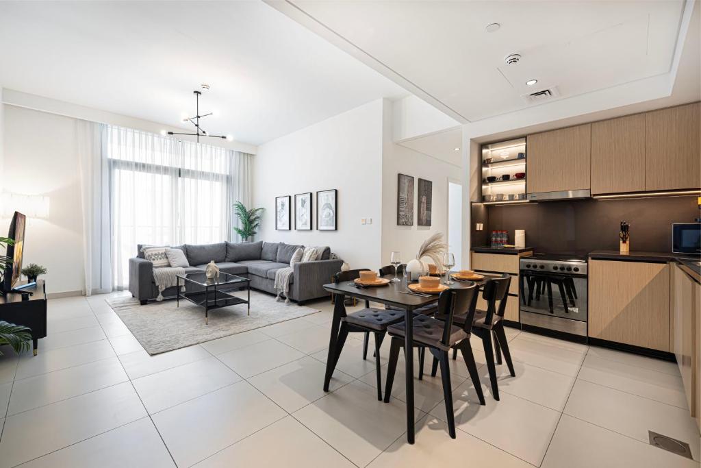 a kitchen and living room with a table and chairs at Burj Crown Luxury 4 Bedroom, Balcony Views, 5 min to Burj Khalifa in Dubai