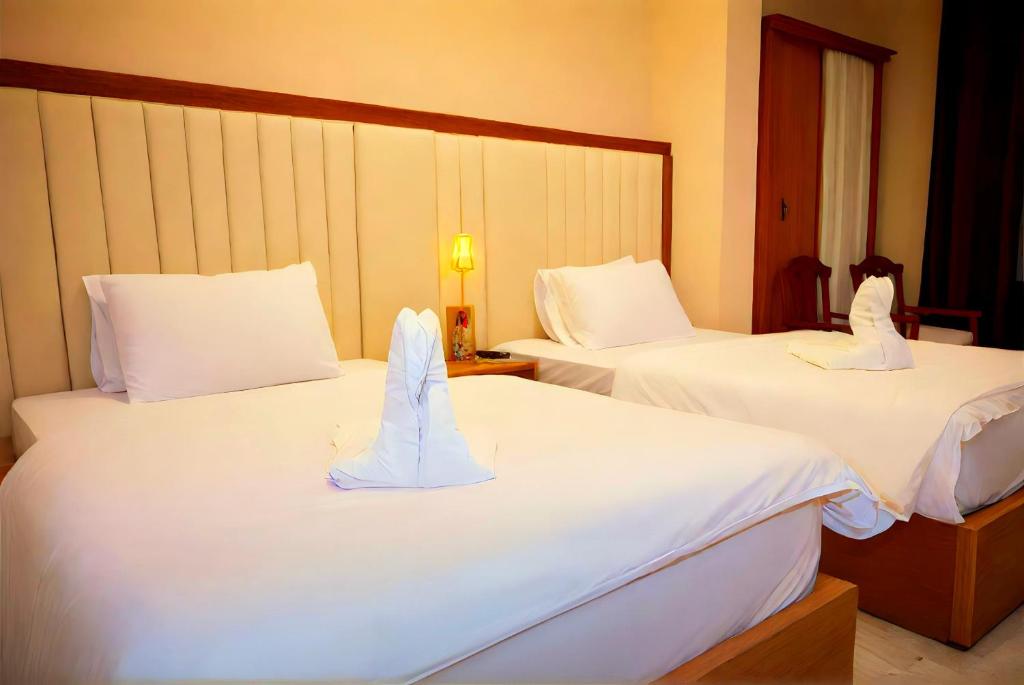Postel nebo postele na pokoji v ubytování Pyramids Grand View Hotel