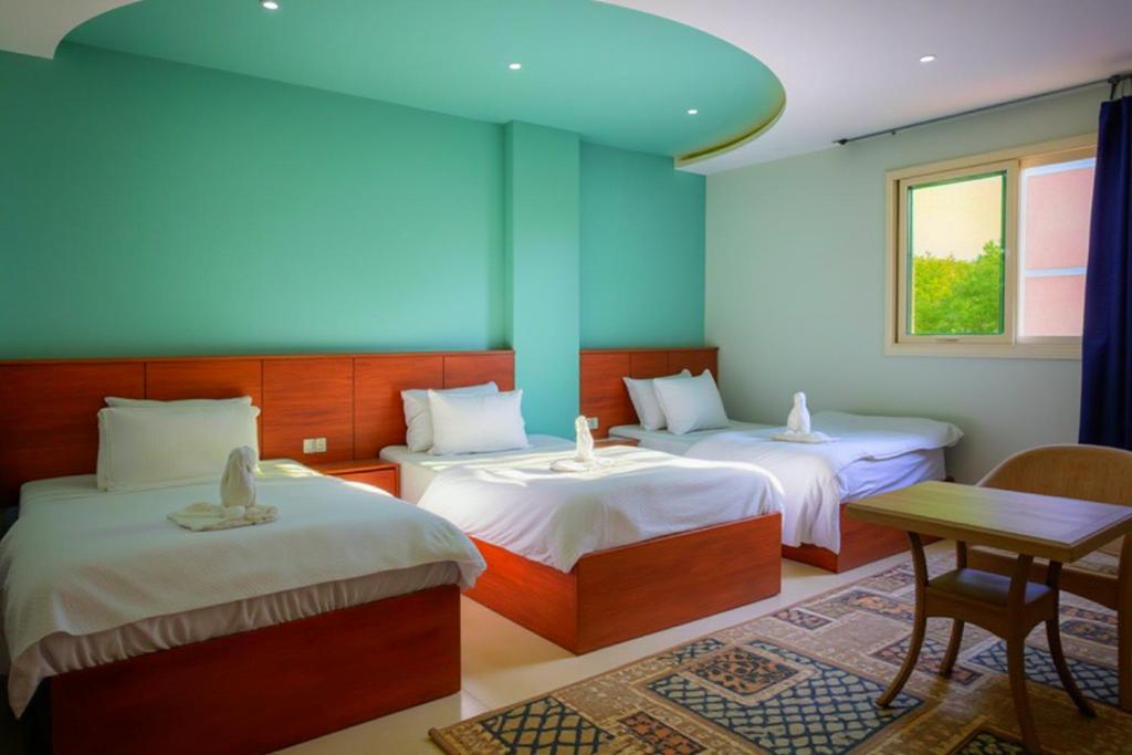 Postel nebo postele na pokoji v ubytování Pyramids Grand View Hotel