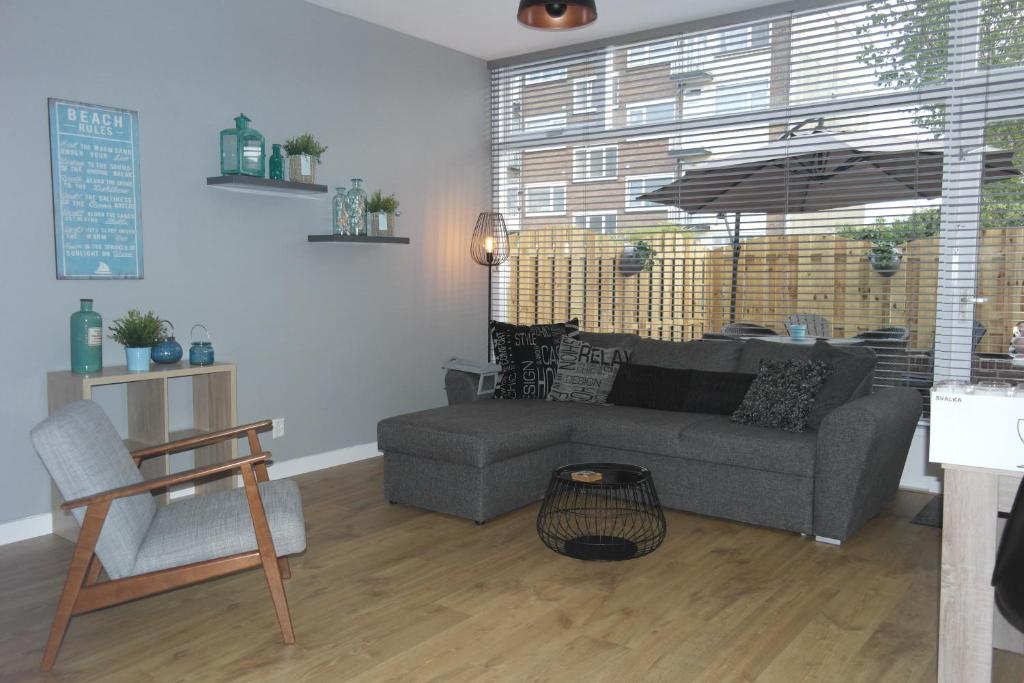 salon z kanapą i parasolem w obiekcie Van Dijk Apartments w Zandvoort