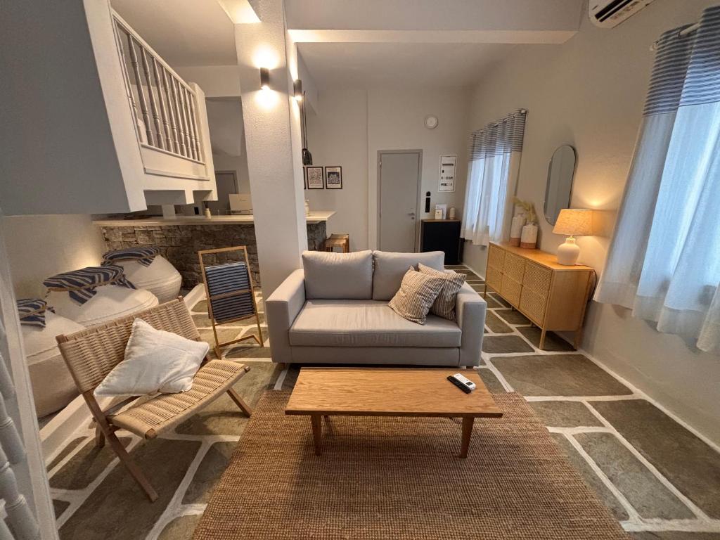 a living room with a couch and a table at Maison Strelitzia "Heritage" - Adults Only in Skiathos Town