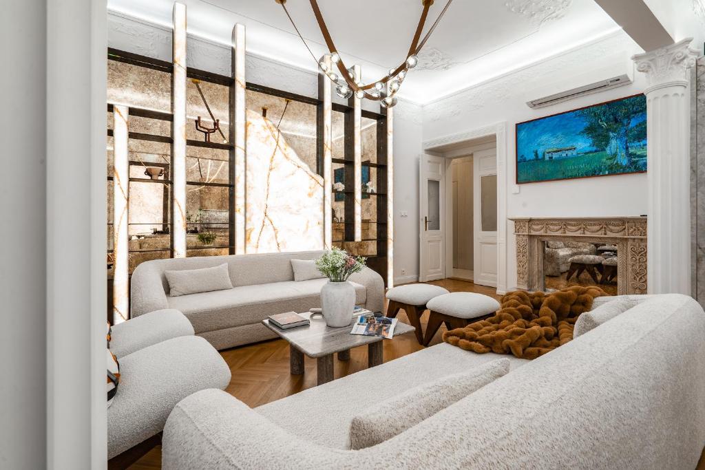 a living room with two couches and a fireplace at Riverside N22 in Prague