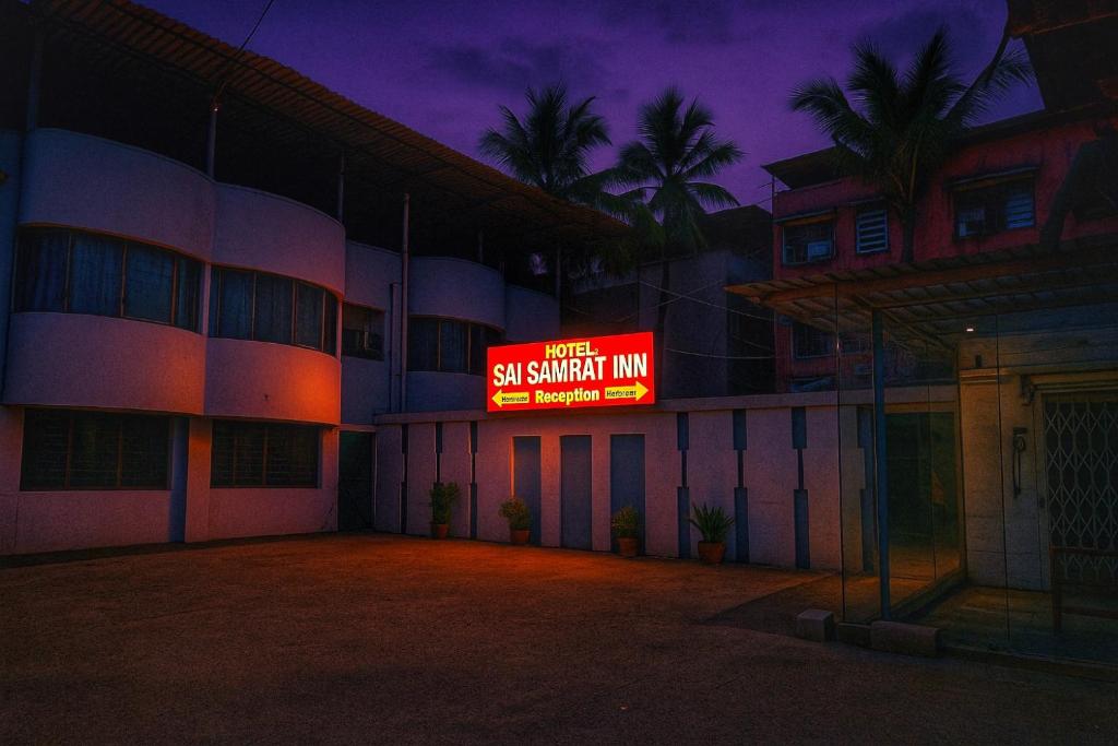 a building with a sign that reads first so smart inn at Hotel Sai Samrat INN in Navi Mumbai