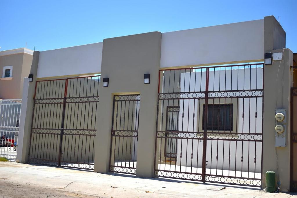a building with four gates on the side of it at House equipped with two bedrooms in La Paz