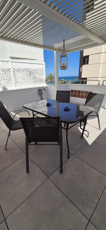 a table and a chair on a patio at Vinaros Beach in Vinarós