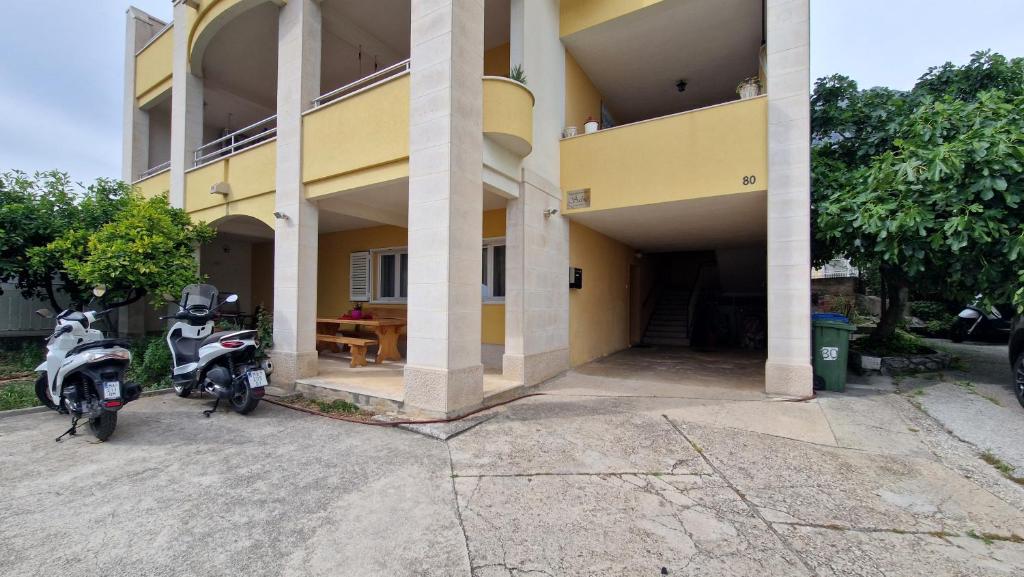 two motorcycles parked in front of a building at Dijana in Makarska
