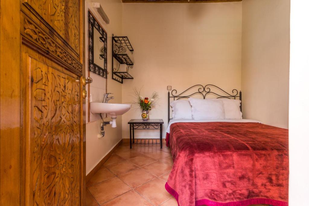 Cama o camas de una habitación en Hotel Atlas