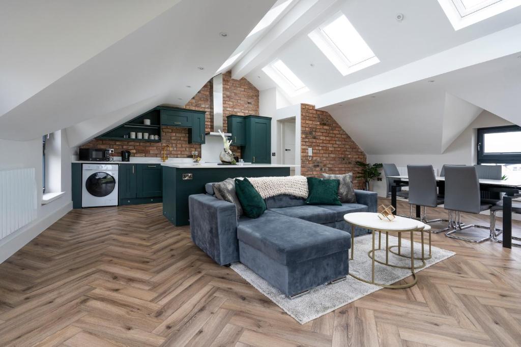 a living room with a couch and a table at 37 West Portrush Luxury Penthouse in Portrush