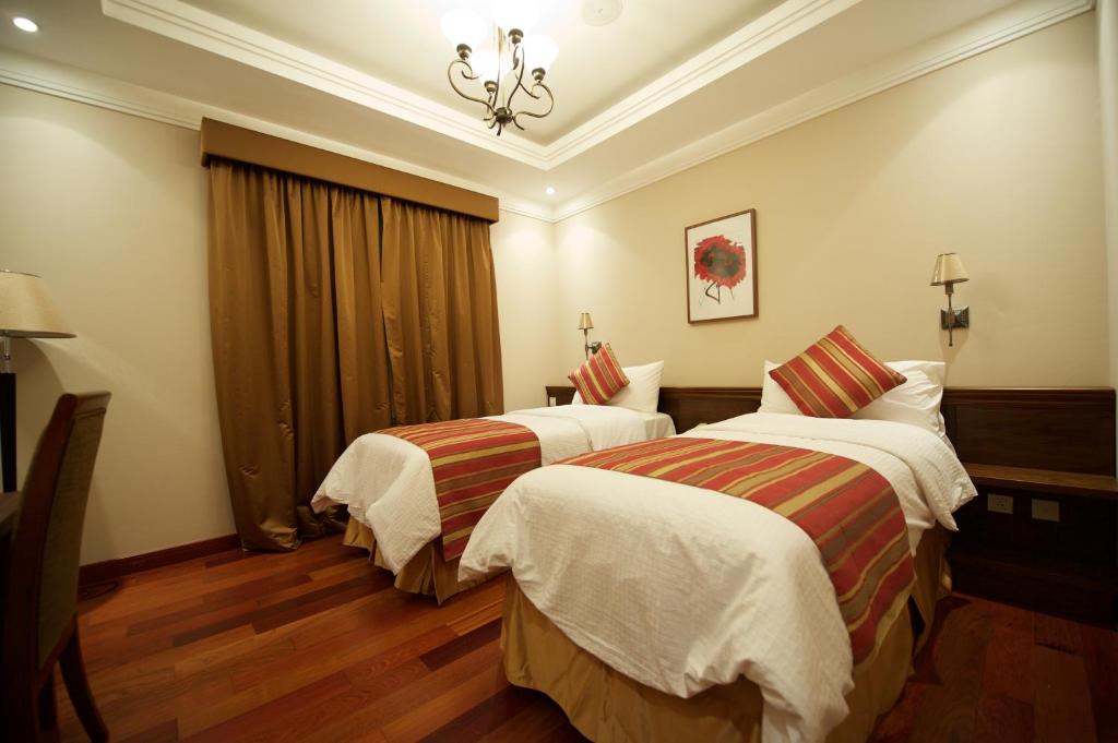 Postel nebo postele na pokoji v ubytování Rawasi Hotel Apartments