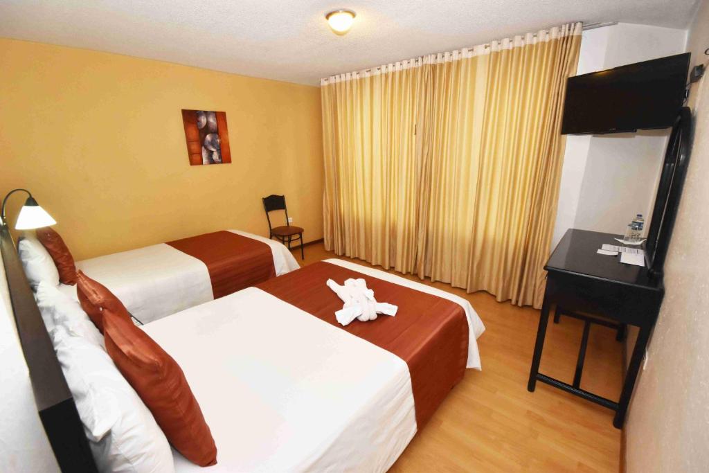 Postel nebo postele na pokoji v ubytování Hotel Montecarlo