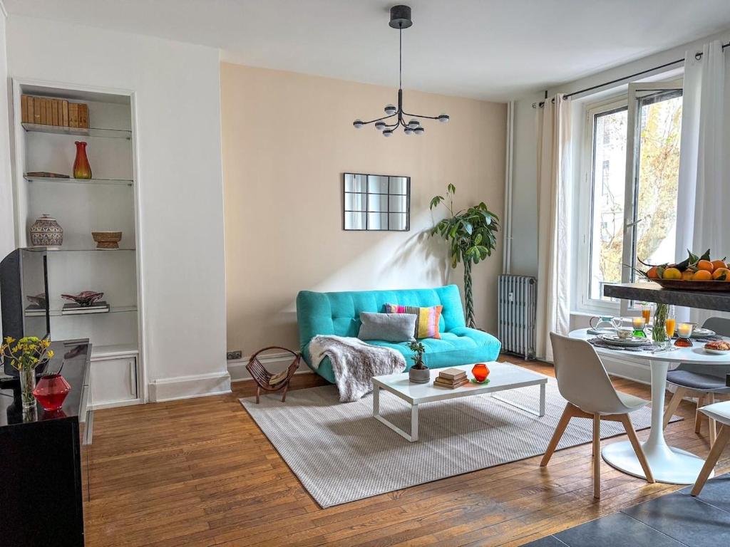 un salon avec un canapé bleu et une table dans l'établissement Nid douillet au cœur de Lyon, à Lyon