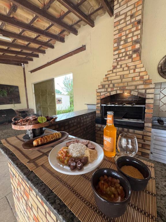 une table avec une plaque de nourriture sur un comptoir dans l'établissement Casa de Campo em Juiz de Fora Granja 6 de Maio, à Chácara