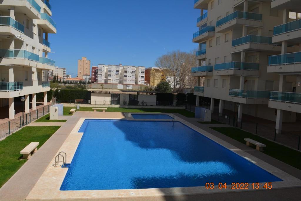 a swimming pool in the middle of a building at Este in La Playa de la Torre de Piles