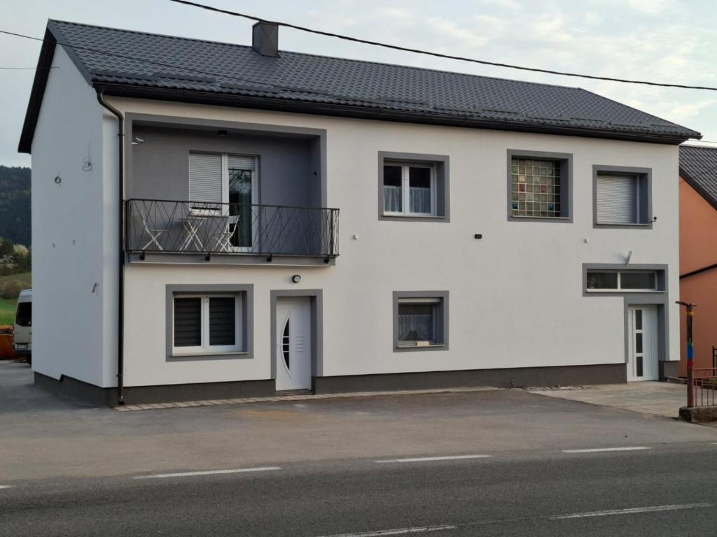 a white house with a black roof at Villa Natasa near Plitvice for 15 persons in Vrhovine