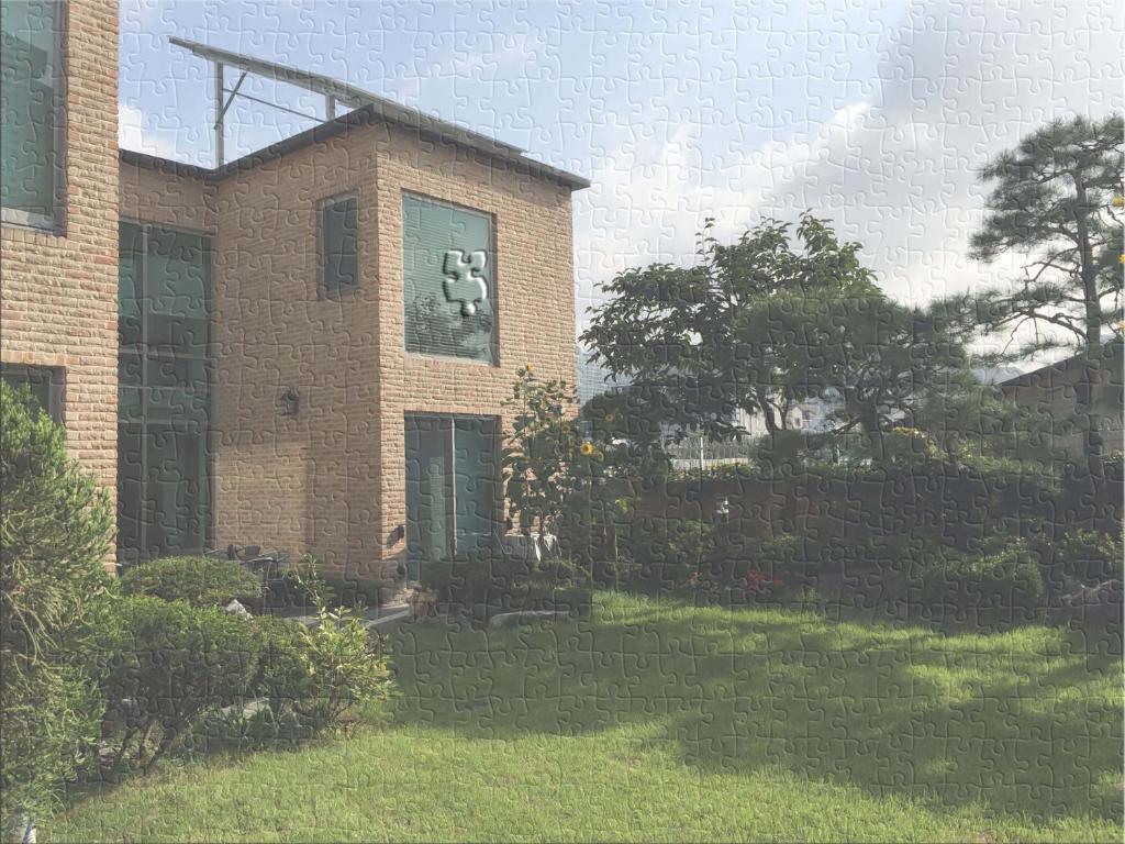 a brick building with a bear in a window at Puzzlestay House in Seoul