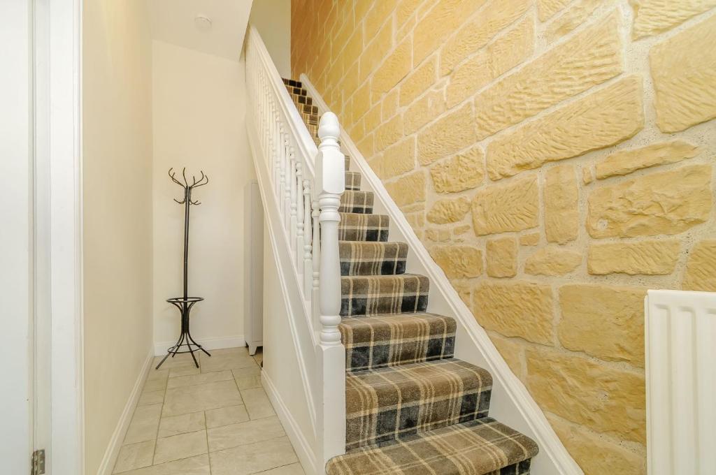 Una escalera en una casa con un muro de piedra. en Roseberry House, en Guisborough