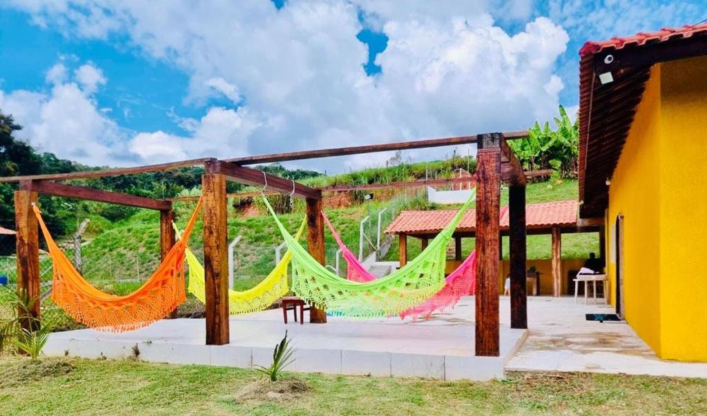 a colorful hammock outside of a house at Recanto bellato in São Roque