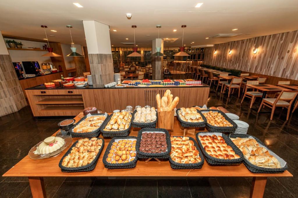 a table filled with lots of different types of food at Hotel Trianon Paulista in Sao Paulo