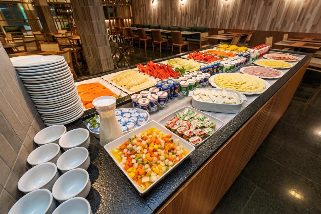 a buffet line with many different types of food at Hotel Trianon Paulista in Sao Paulo