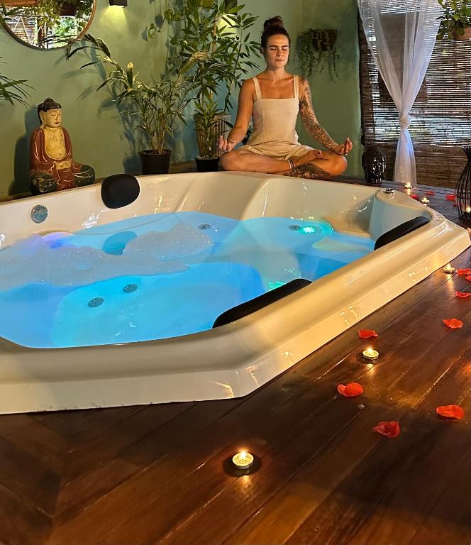 a woman is sitting in a bath tub at Pousada Pura vida in Itacaré