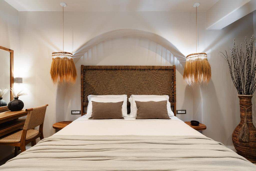 a bedroom with a large bed with two pillows at Chic Elysium Bliss in Naxos Chora