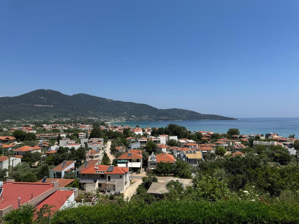 a view of a town with the ocean in the background at Magic Sea View - Golden Beach in Skala Potamias