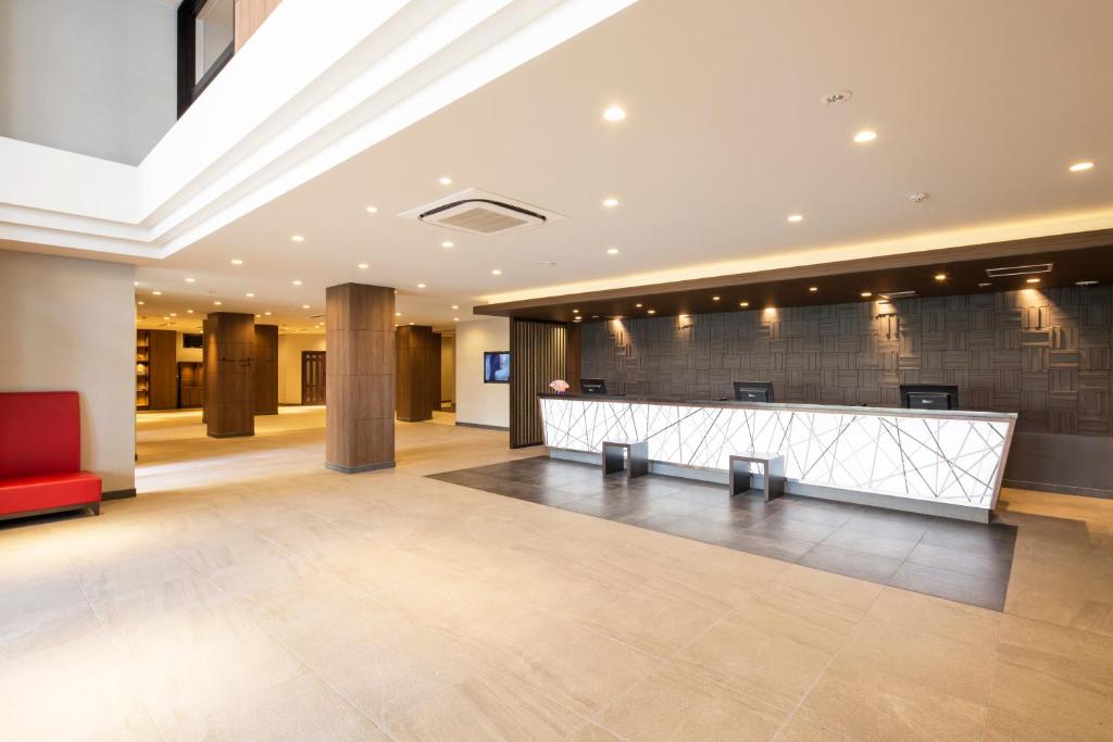 a lobby with a reception desk in a building at HOTEL MYSTAYS Kanazawa Castle in Kanazawa