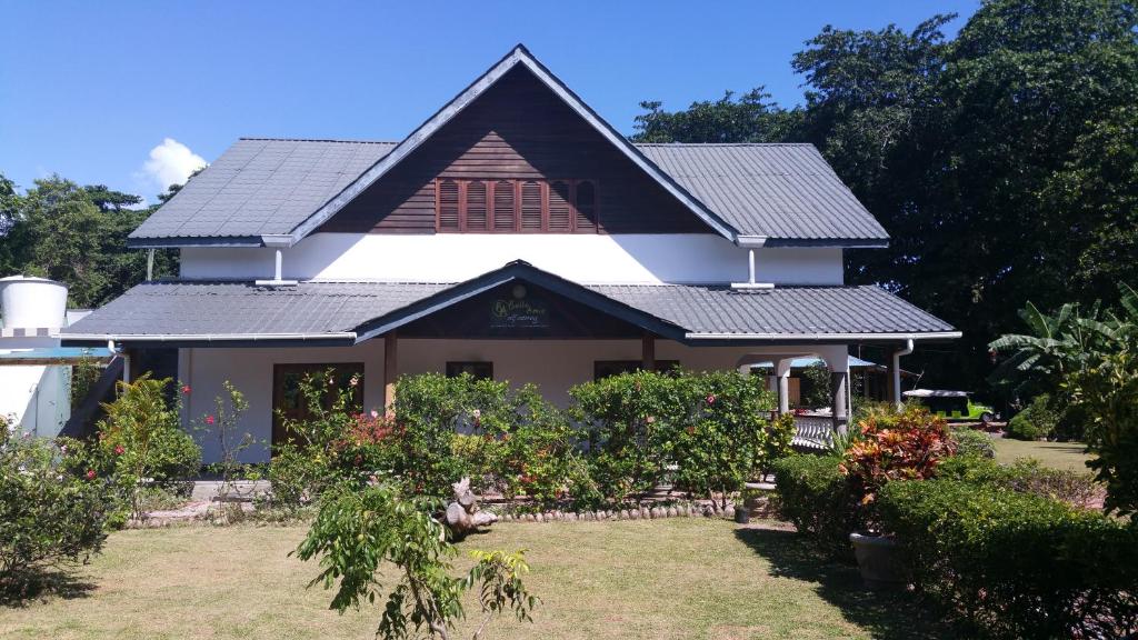 a house with solar panels on the roof at Belle Amie Self Catering in La Digue