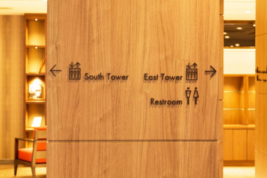 a wooden door with the words south tower east tower and return room at HOTEL MYSTAYS Kanazawa Castle in Kanazawa