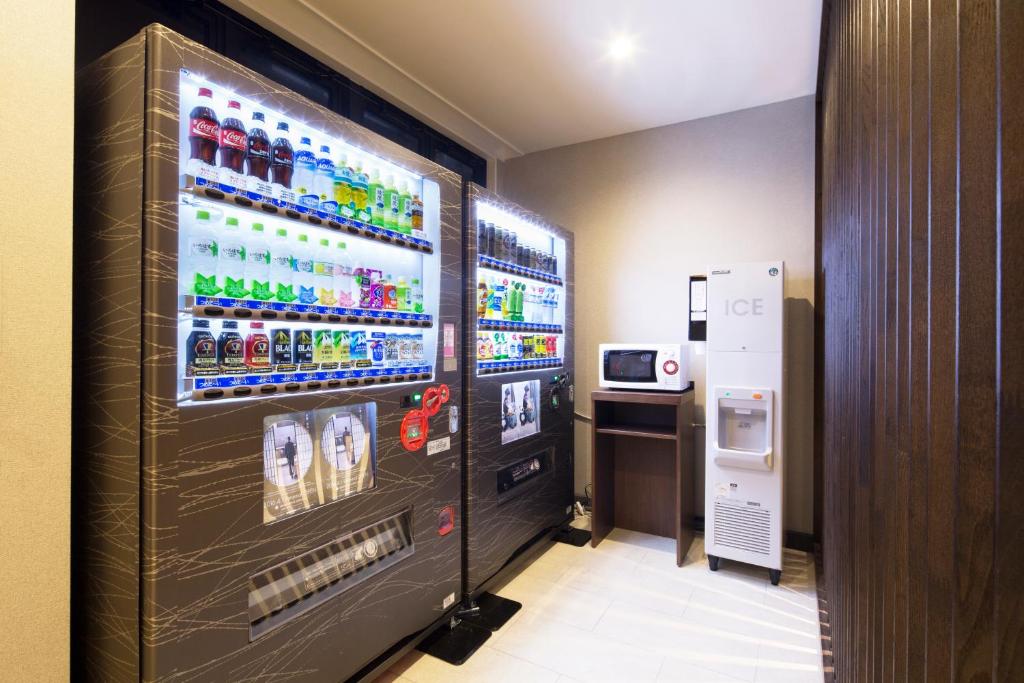 a vending machine with drinks in a room at HOTEL MYSTAYS Kanazawa Castle in Kanazawa