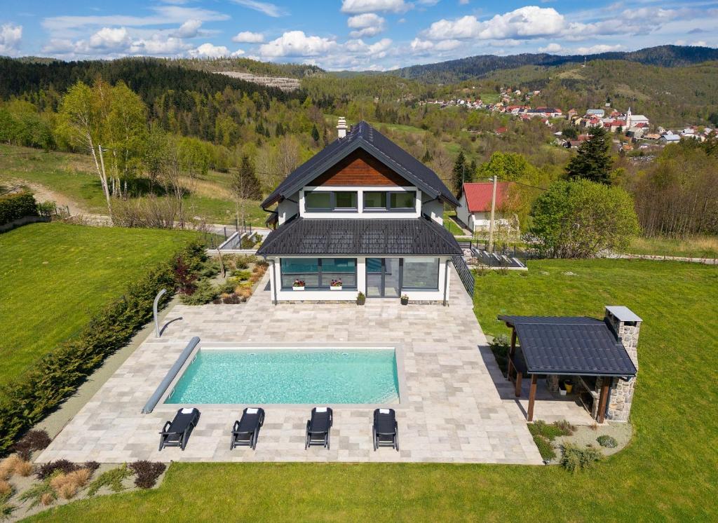 an aerial view of a house with a swimming pool at Villa ESEN - Fužine in Fužine
