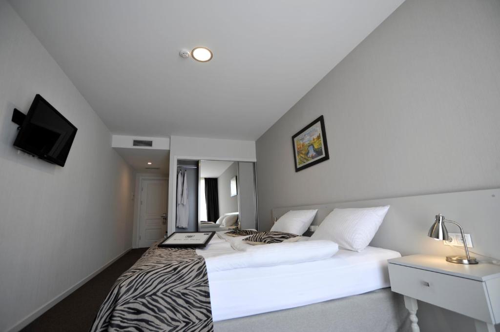 Postel nebo postele na pokoji v ubytování Hotel ZP Palace