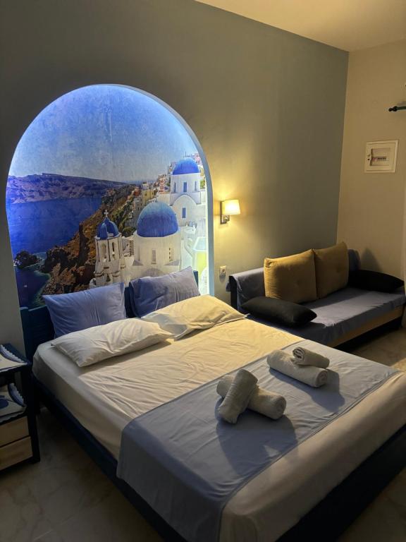 a hotel room with two beds and a window at Victoria's Blue studios in Siviri