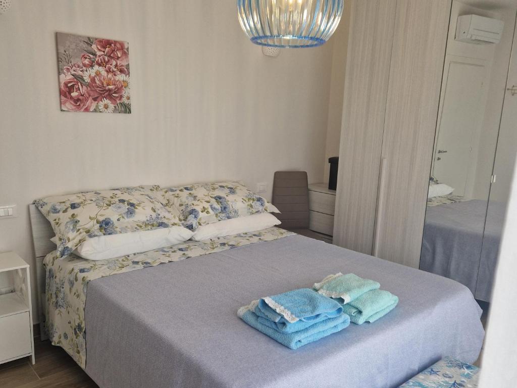 a bedroom with a bed with towels on it at Paradiso al mare in Marina di Massa