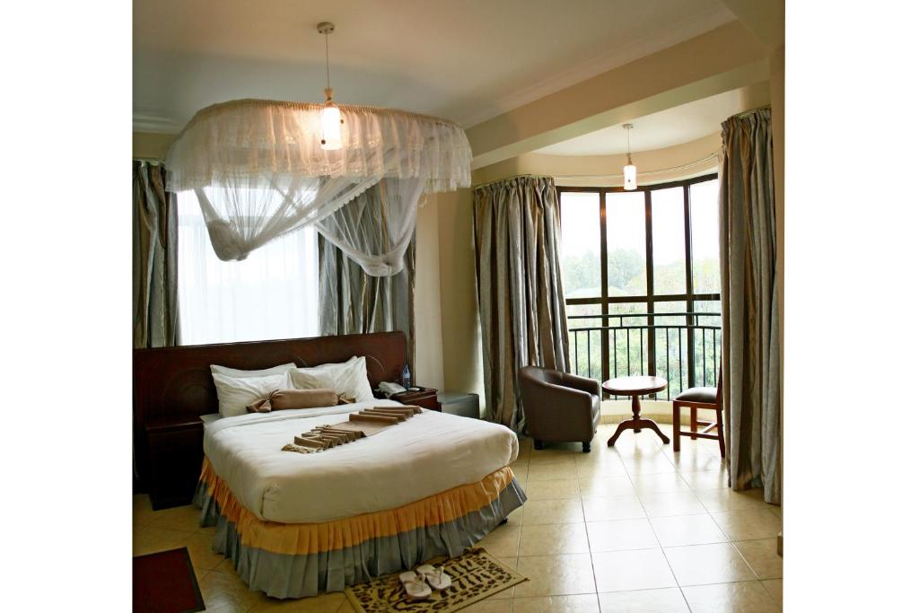 מיטה או מיטות בחדר ב-Grace Land Hotel