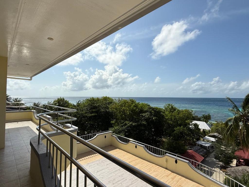 a balcony with a view of the ocean at Noah Family Room with Seaview Balcony in Himmafushi