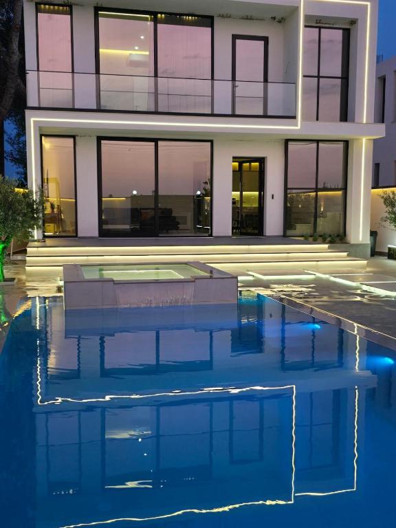 a house with a pool in front of it at Aventus Luxury Villa in Rrushkull