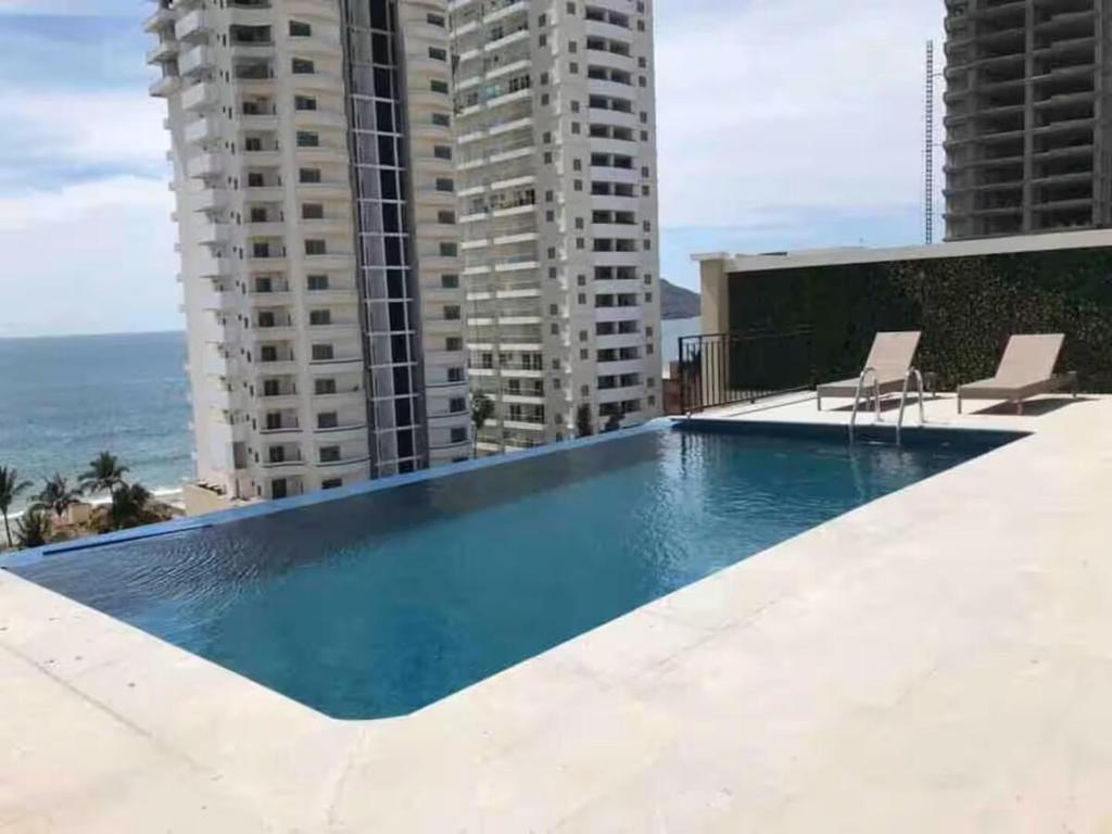a swimming pool on the roof of a building at Espectacular condo en Blue Marlin Zona Dorada Beach in Mazatlán