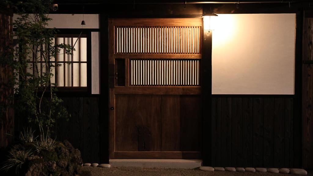 a door with a light on the side of a building at 辰巳屋 Tatsumiya in Osaka