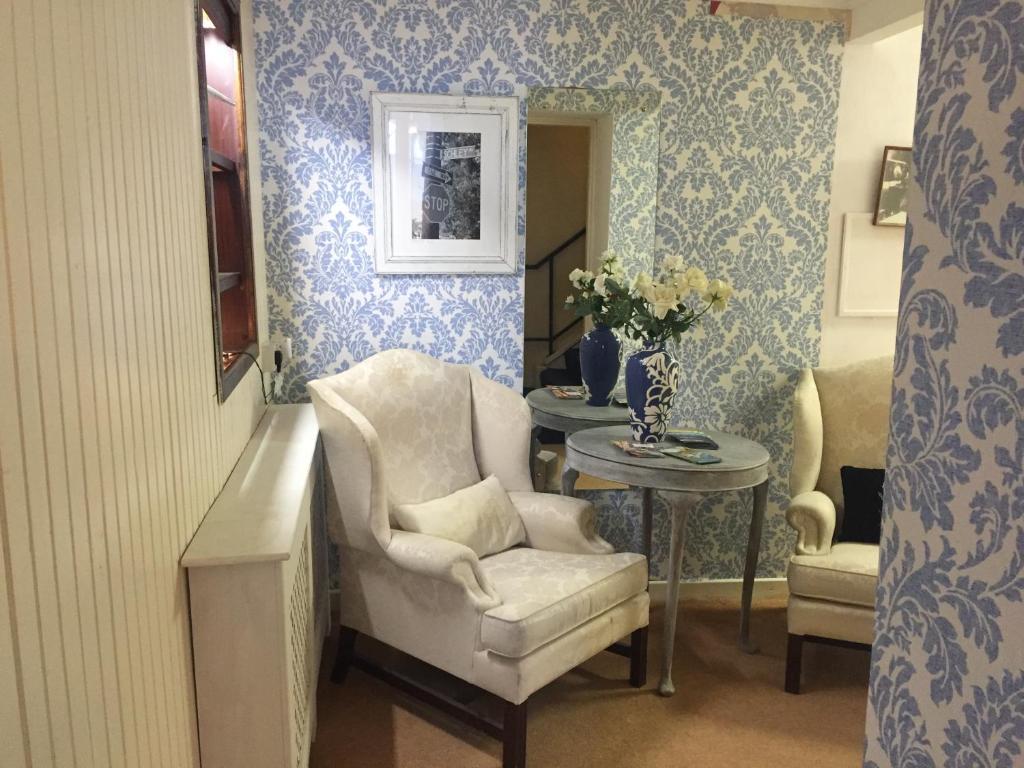 a living room with a chair and a table at Errismore House in Clifden