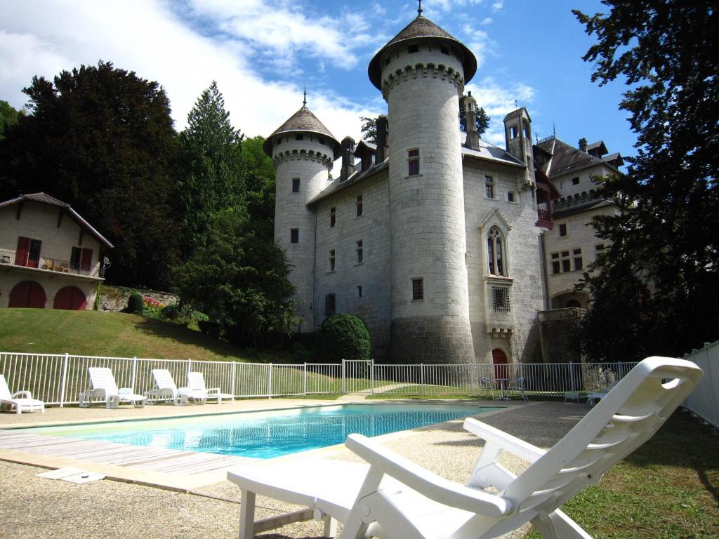 - un château avec une piscine en face dans l'établissement Castle Apartment in France with Pool, cleaning included, à Serrières-en-Chautagne