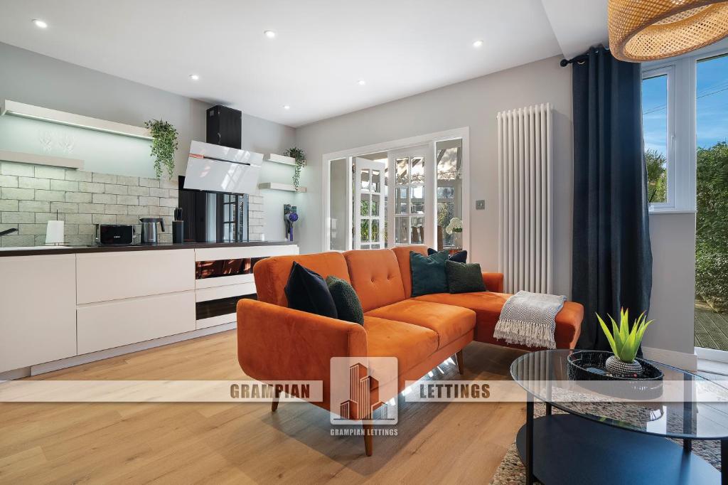 a living room with a couch and a table at The Northern House - Grampian Lettings in Aberdeen