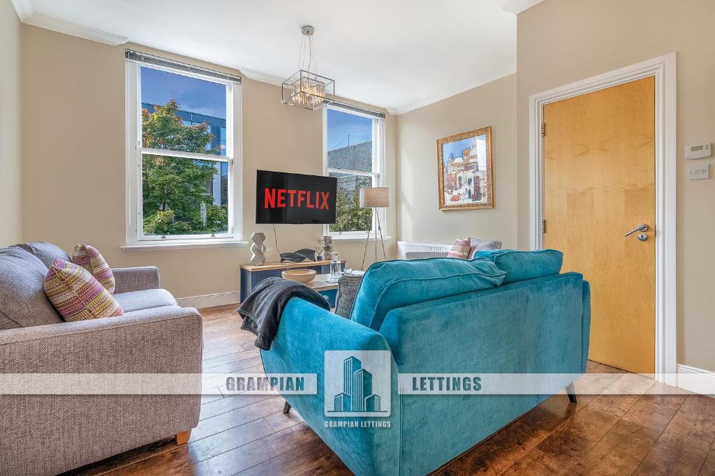 un salon avec un canapé et une chaise dans l'établissement Crimon Place Townhouse - Grampian Lettings Ltd, à Aberdeen