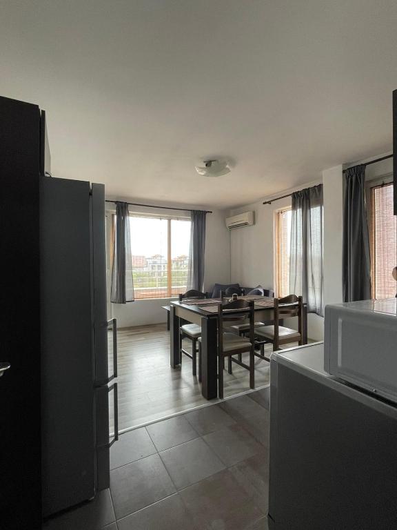 a kitchen and living room with a table and chairs at Adagio Sarafovo in Burgas