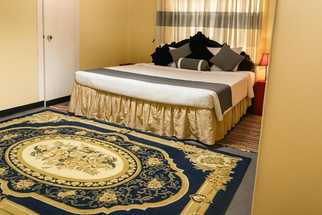 a bedroom with a bed with a blue and gold rug at Lotus Mountain Retreat in Kandy