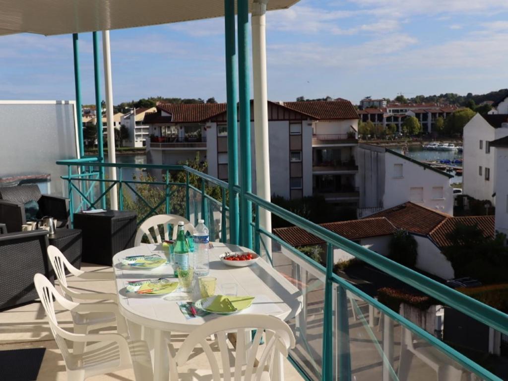 a white table and chairs on a balcony with a view at Appartement à Ciboure avec piscine chauffée et parking privé - FR-1-239-560 in Ciboure