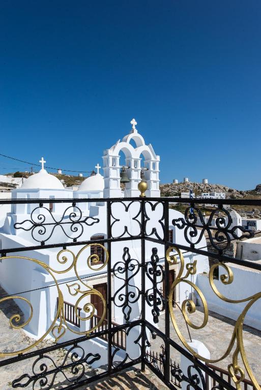 a black iron fence with a building in the background at Thomas Traditional House in Chora in Amorgos