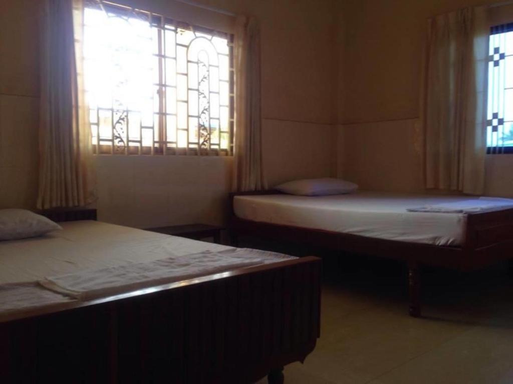 Postel nebo postele na pokoji v ubytování Ta Eng Guesthouse