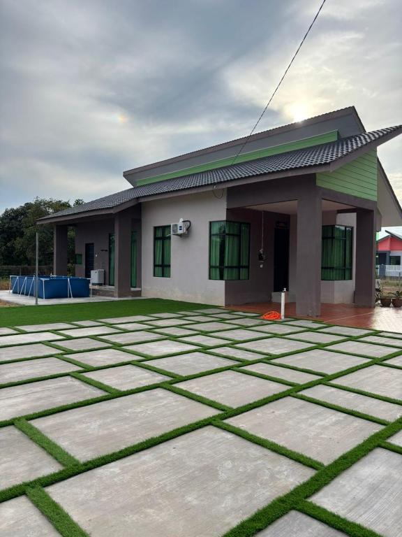 a house with a lot of grass in front of it at Berangan Green in Kuala Terengganu